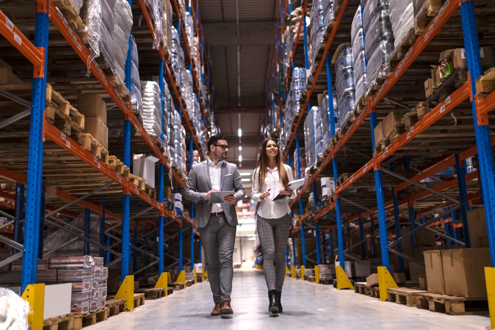 Warehouse managers walking through a large distribution centre